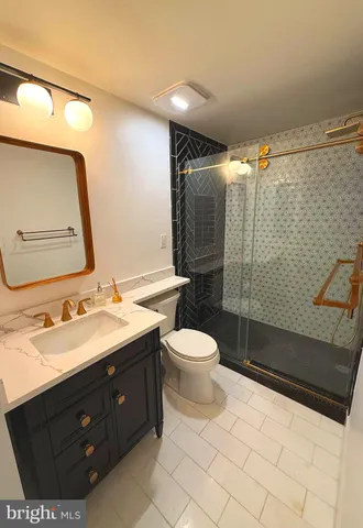a bathroom with a double vanity sink toilet and shower