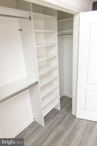 a view of walk in closet with empty racks