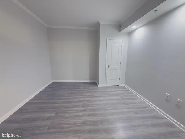 a view of an empty room and wooden floor