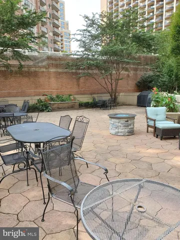 a view of yard with seating space and trees in the background