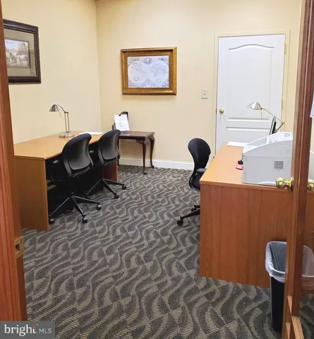 a work place with furniture and rug