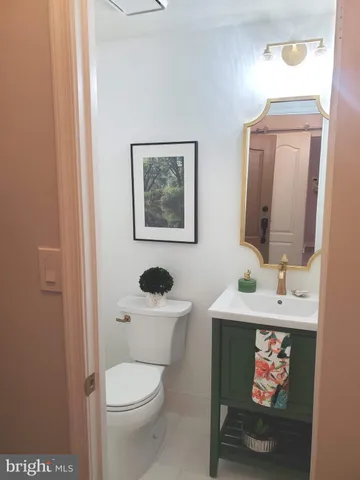 a bathroom with a toilet a sink and mirror