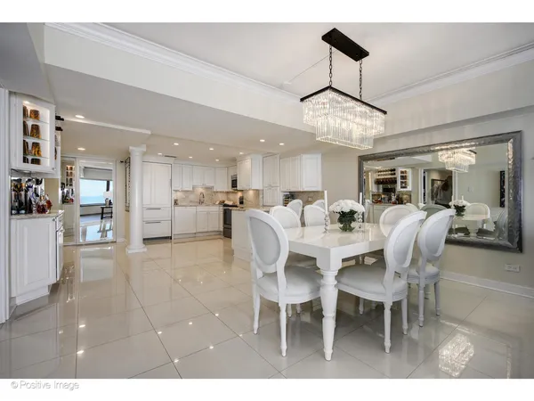 a dining room with furniture and view of a chandelier