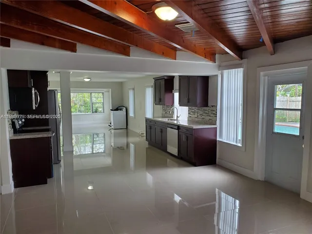 a kitchen with stainless steel appliances granite countertop a refrigerator and a stove