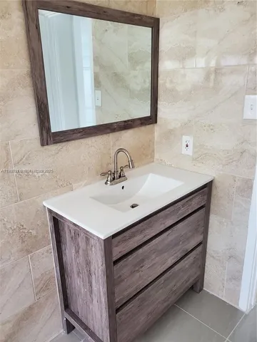 a bathroom with a sink vanity and a mirror