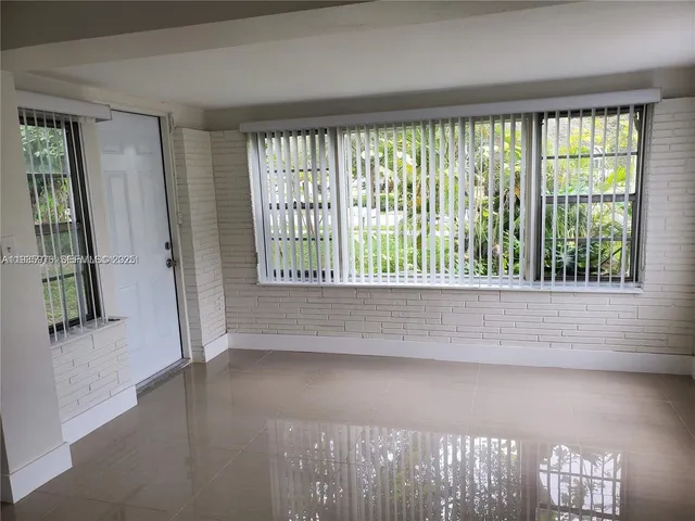 a view of hallway with stairs and wooden floor