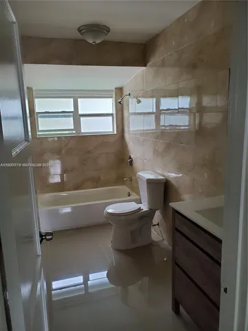 a bathroom with a toilet a sink and a bathtub