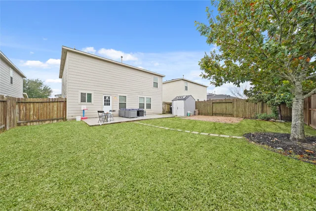 a view of a house with backyard and sitting area