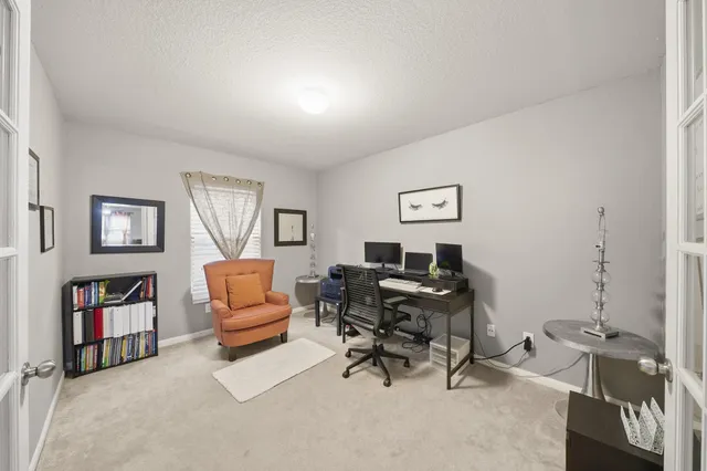 a living room with furniture and a bookshelf