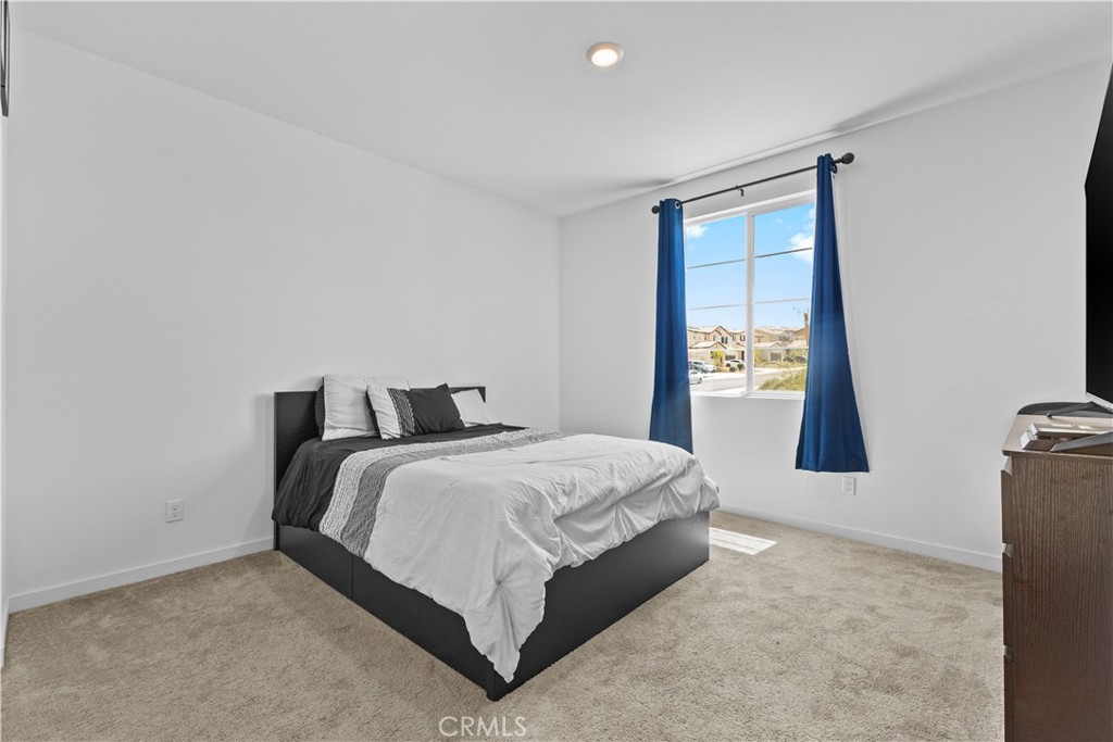 36780 Arietta Way Beaumont, CA 92223 - Photo 15 of 44 a bedroom with a bed and painting on the wall