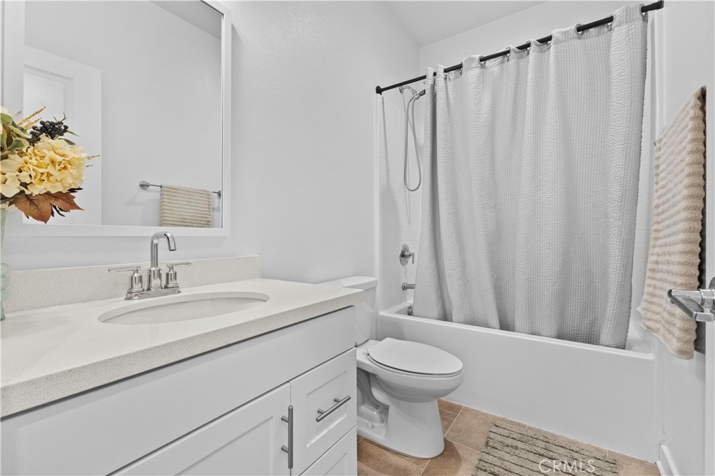 36780 Arietta Way Beaumont, CA 92223 - Photo 16 of 44 a bathroom with a toilet a sink and a mirror