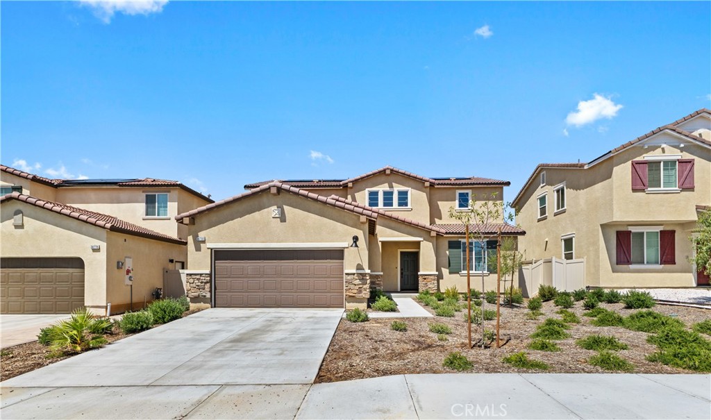 36780 Arietta Way Beaumont, CA 92223 - Photo 2 of 44 a front view of a house with a garden