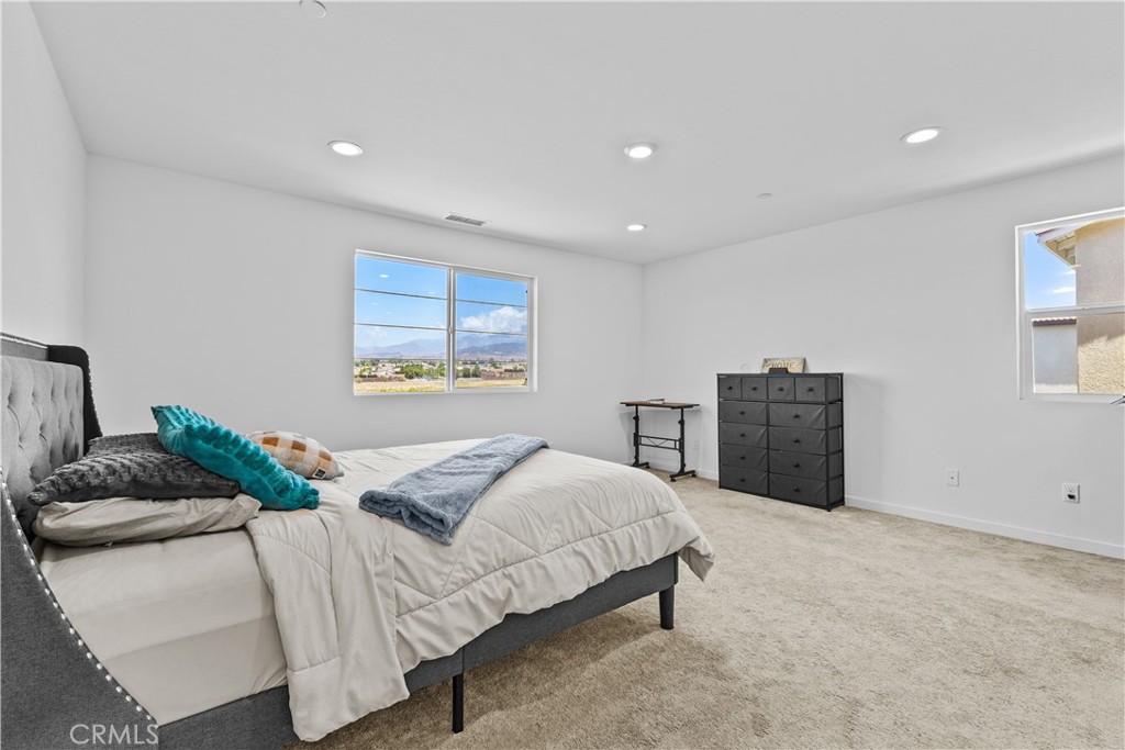 36780 Arietta Way Beaumont, CA 92223 - Photo 21 of 44 a bedroom with a bed and a couch