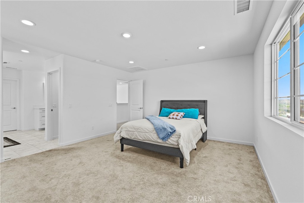 36780 Arietta Way Beaumont, CA 92223 - Photo 23 of 44 a bed sitting in a spacious bedroom next to a window