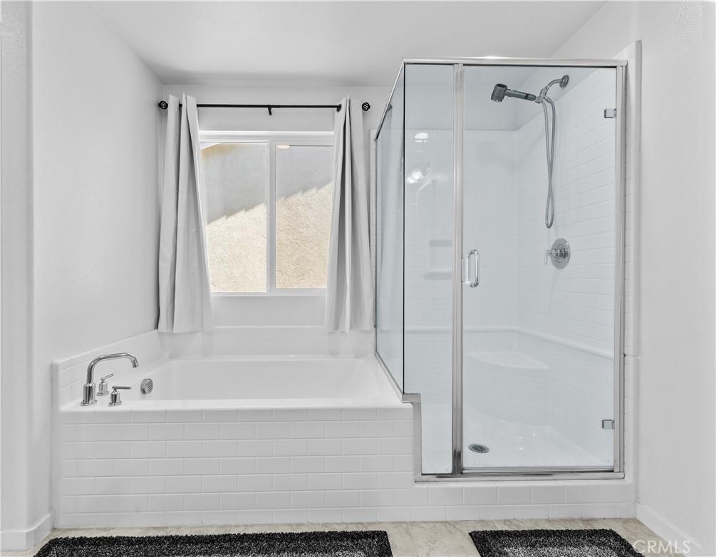 36780 Arietta Way Beaumont, CA 92223 - Photo 25 of 44 a bathroom with a bathtub and a shower