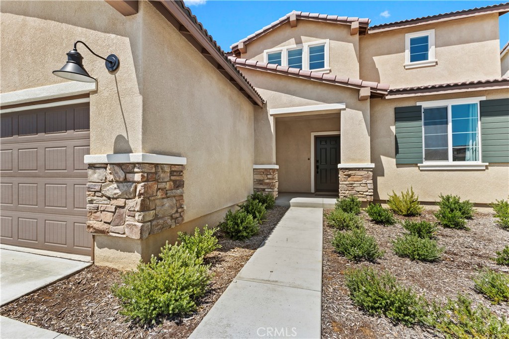 36780 Arietta Way Beaumont, CA 92223 - Photo 3 of 44 a front view of a house with garden