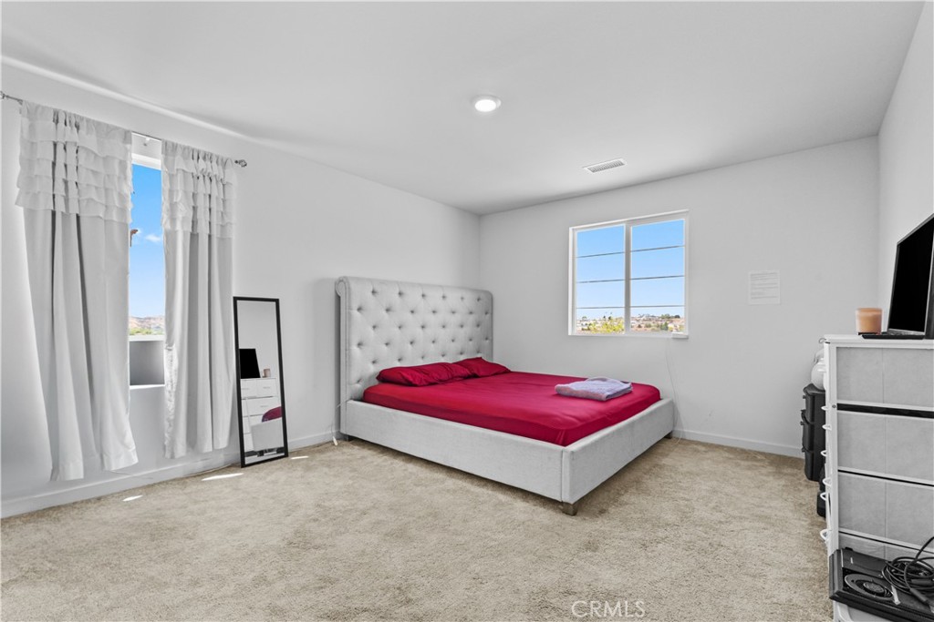 36780 Arietta Way Beaumont, CA 92223 - Photo 31 of 44 a bedroom with a bed and a window
