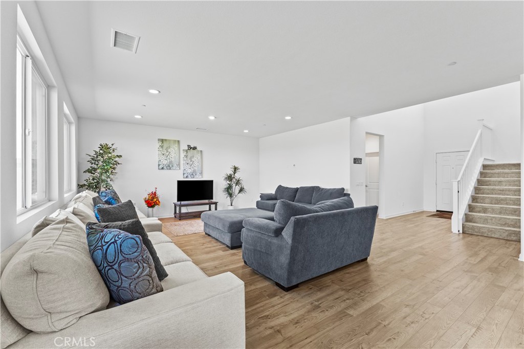 36780 Arietta Way Beaumont, CA 92223 - Photo 6 of 44 a living room with furniture and a wooden floor
