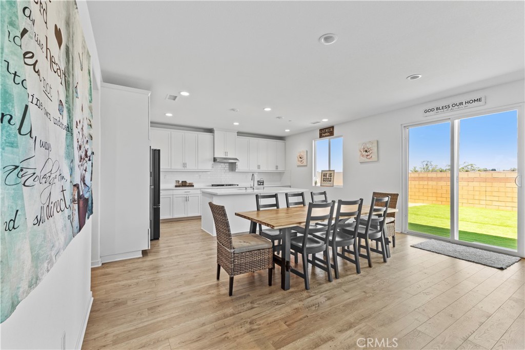 36780 Arietta Way Beaumont, CA 92223 - Photo 8 of 44 a view of a dining room with furniture and wooden floor