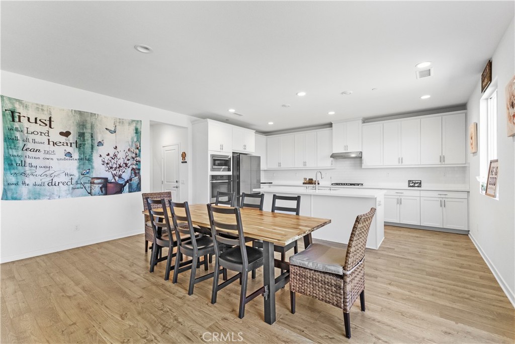 36780 Arietta Way Beaumont, CA 92223 - Photo 9 of 44 a view of a dining room with furniture and wooden floor