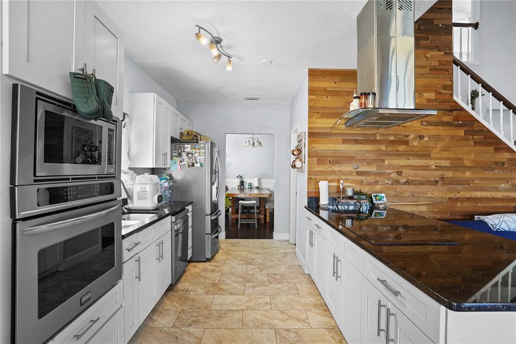 2619 Rangeley Court Orlando, FL 32835 - Photo 20 of 59 a large kitchen with stainless steel appliances granite countertop a stove and a refrigerator