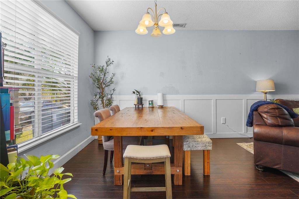 2619 Rangeley Court Orlando, FL 32835 - Photo 23 of 59 a view of a dining room with furniture window and wooden floor