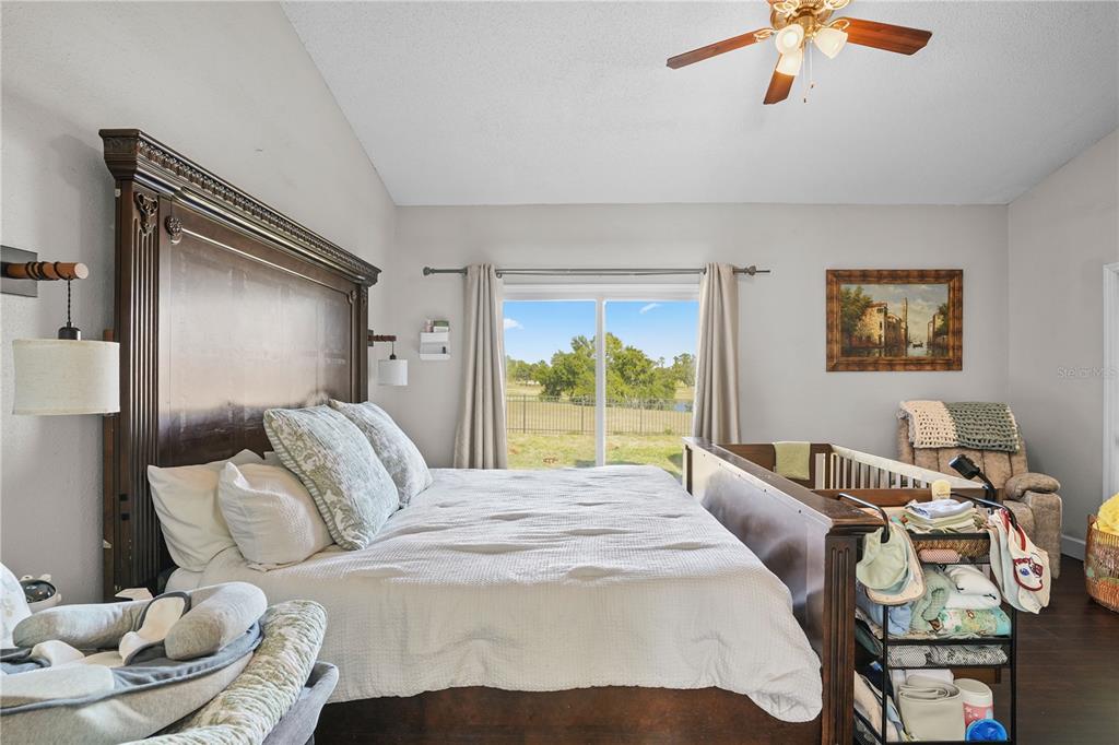 2619 Rangeley Court Orlando, FL 32835 - Photo 27 of 59 a bedroom with a bed and wooden floor