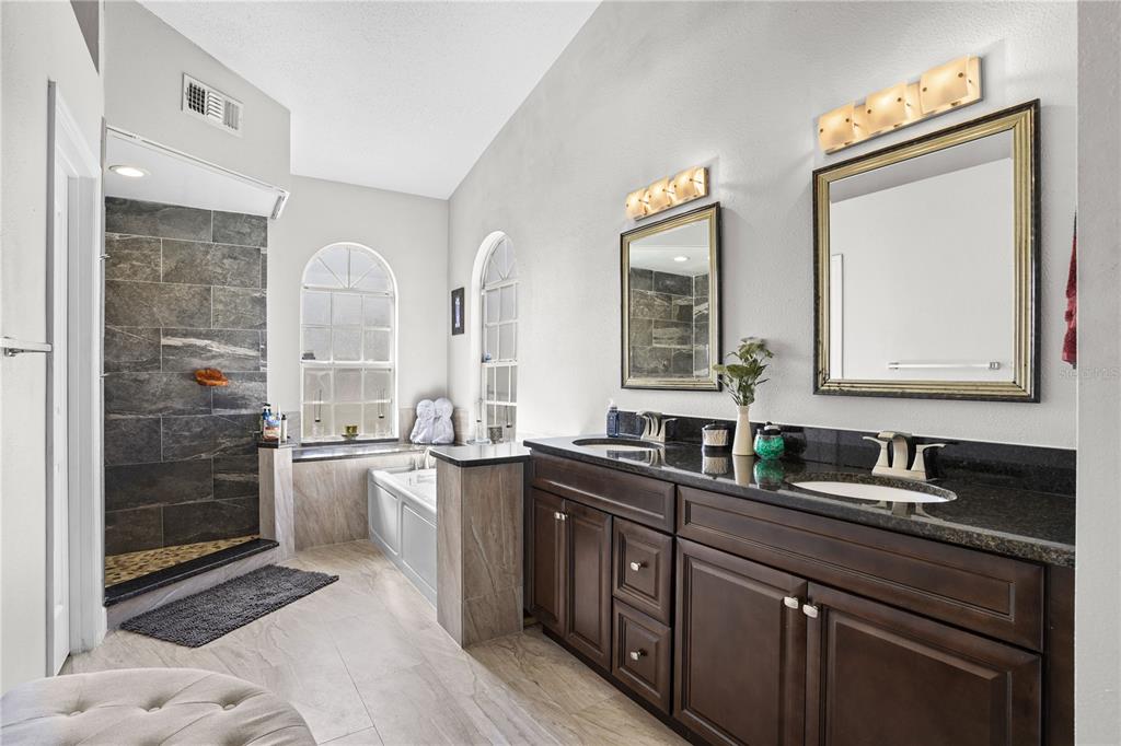 2619 Rangeley Court Orlando, FL 32835 - Photo 28 of 59 a kitchen with stainless steel appliances granite countertop a sink stove and refrigerator