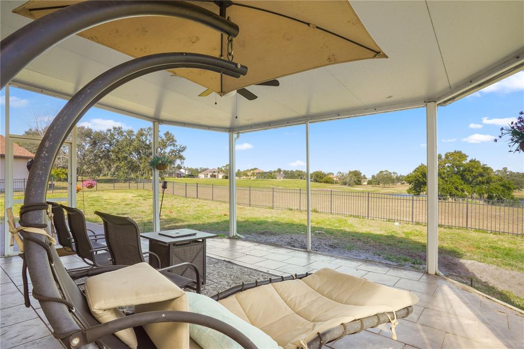 2619 Rangeley Court Orlando, FL 32835 - Photo 31 of 59 a view of a patio with a table chairs and a backyard