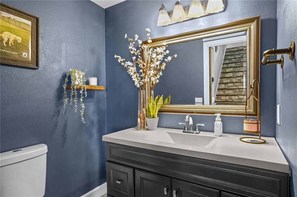 2619 Rangeley Court Orlando, FL 32835 - Photo 36 of 59 a bathroom with a sink a toilet and mirror