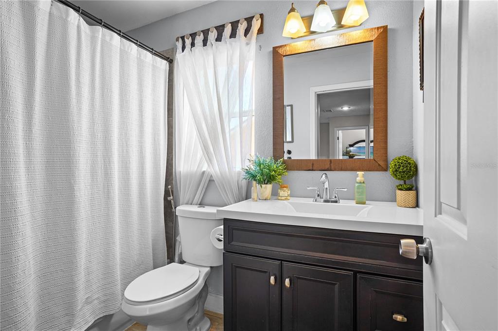 2619 Rangeley Court Orlando, FL 32835 - Photo 41 of 59 a bathroom with a sink a toilet and shower curtain