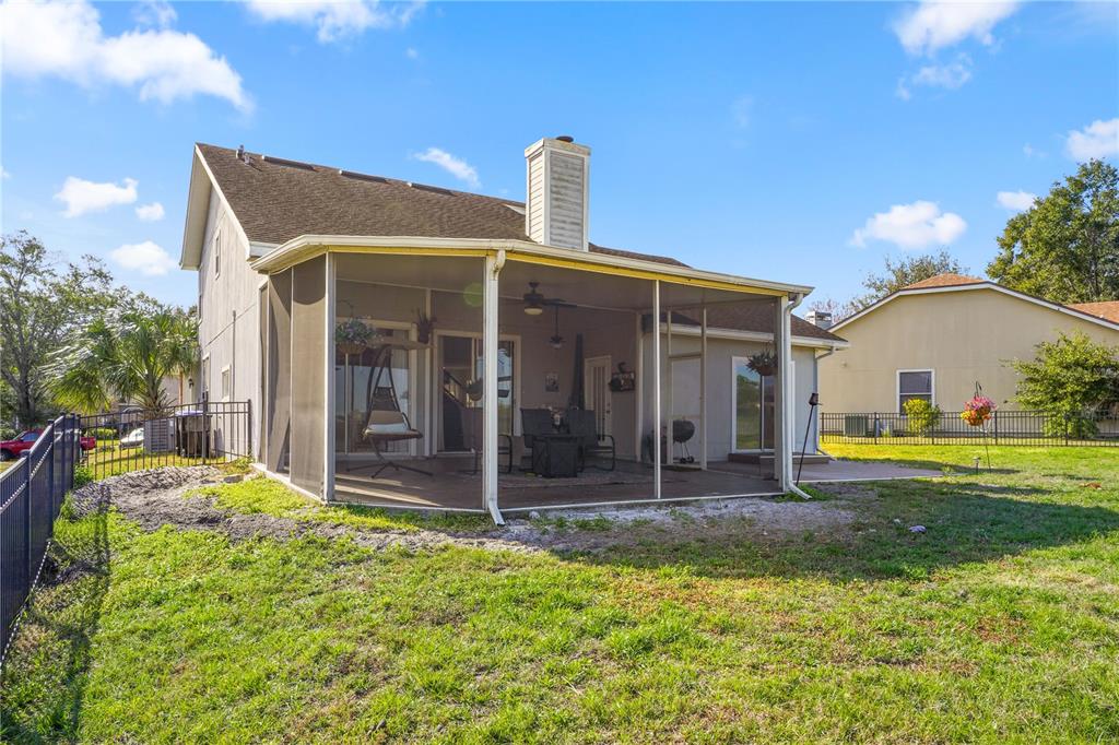 2619 Rangeley Court Orlando, FL 32835 - Photo 49 of 59 a front view of house with a garden and patio