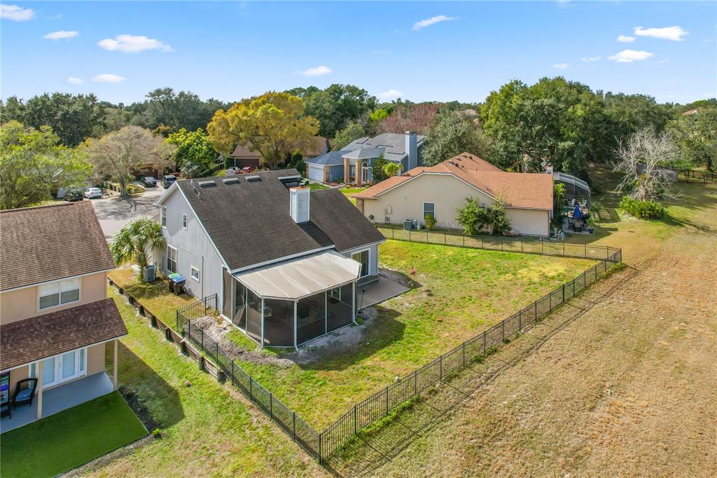 2619 Rangeley Court Orlando, FL 32835 - Photo 52 of 59 a view of a house with a big yard and large trees
