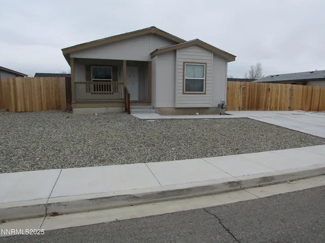 a view of a house with a yard and wooden fence