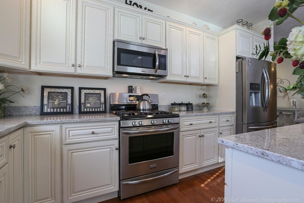 3 Dunrobin Circle, Unit 3 Methuen, MA 01844 - Photo 11 of 28 a kitchen with granite countertop white cabinets stainless steel appliances and a sink