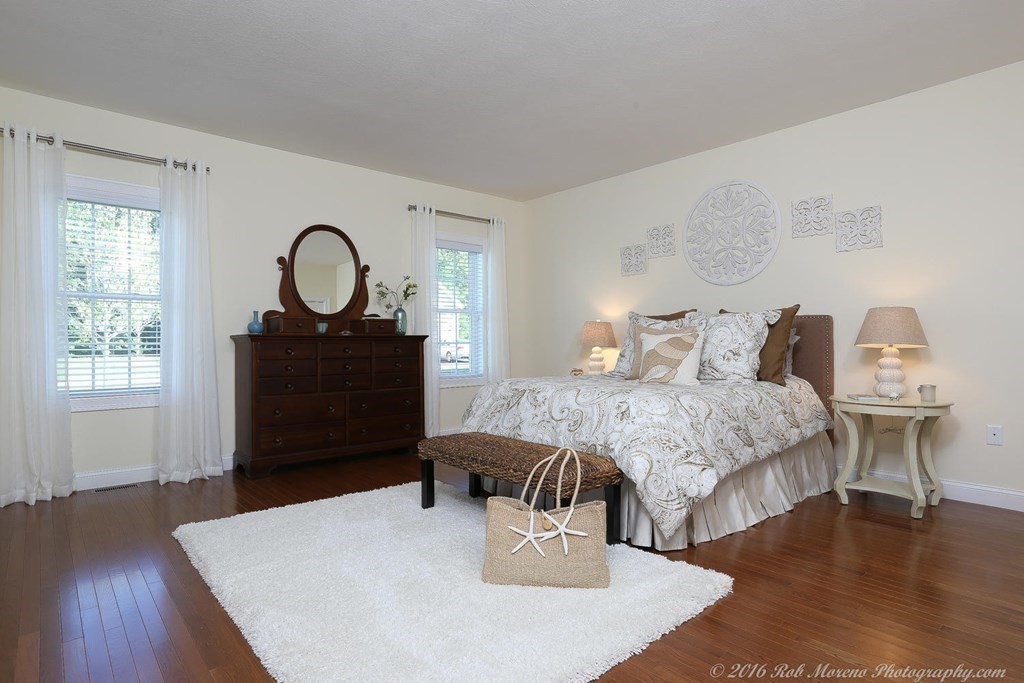 3 Dunrobin Circle, Unit 3 Methuen, MA 01844 - Photo 15 of 28 a bedroom with a bed a dresser and wooden floor