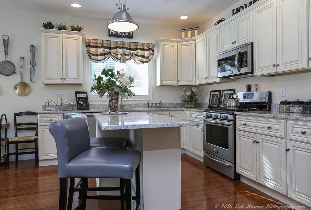 3 Dunrobin Circle, Unit 3 Methuen, MA 01844 - Photo 8 of 28 a kitchen with stainless steel appliances granite countertop a table chairs sink and cabinets
