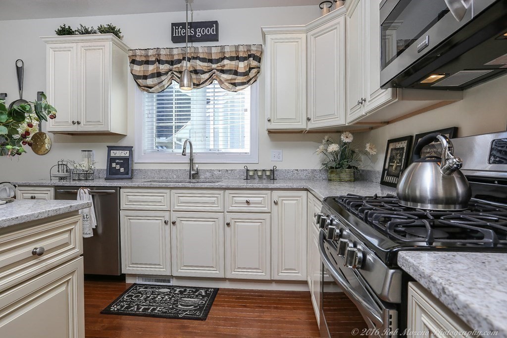 3 Dunrobin Circle, Unit 3 Methuen, MA 01844 - Photo 9 of 28 a kitchen with a sink stove and cabinets