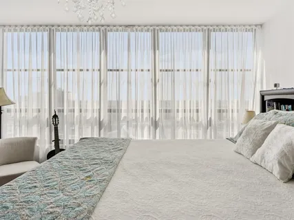 a spacious bedroom with a bed and a couch