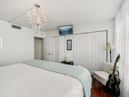 a bedroom with a bed and a chandelier