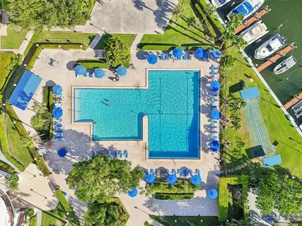 a dining hall with stainless steel appliances refrigerator stove dining table and chairs