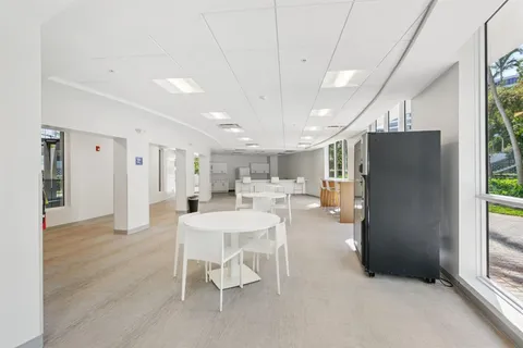 a kitchen with granite countertop a stove and white cabinets