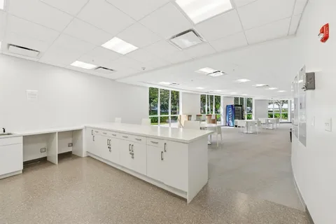 a view of a dining room with furniture and a window