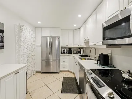 a kitchen with a stove a refrigerator and a sink
