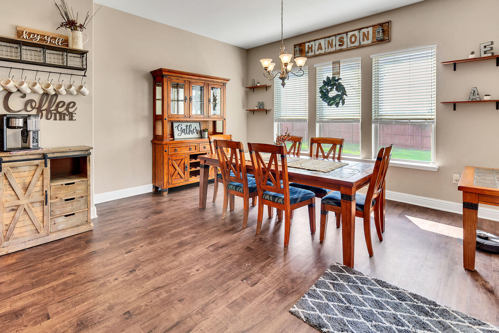 3044 Crown Creek Circle Crestview, FL 32539 - Photo 15 of 41 a dining room with furniture a chandelier and wooden floor