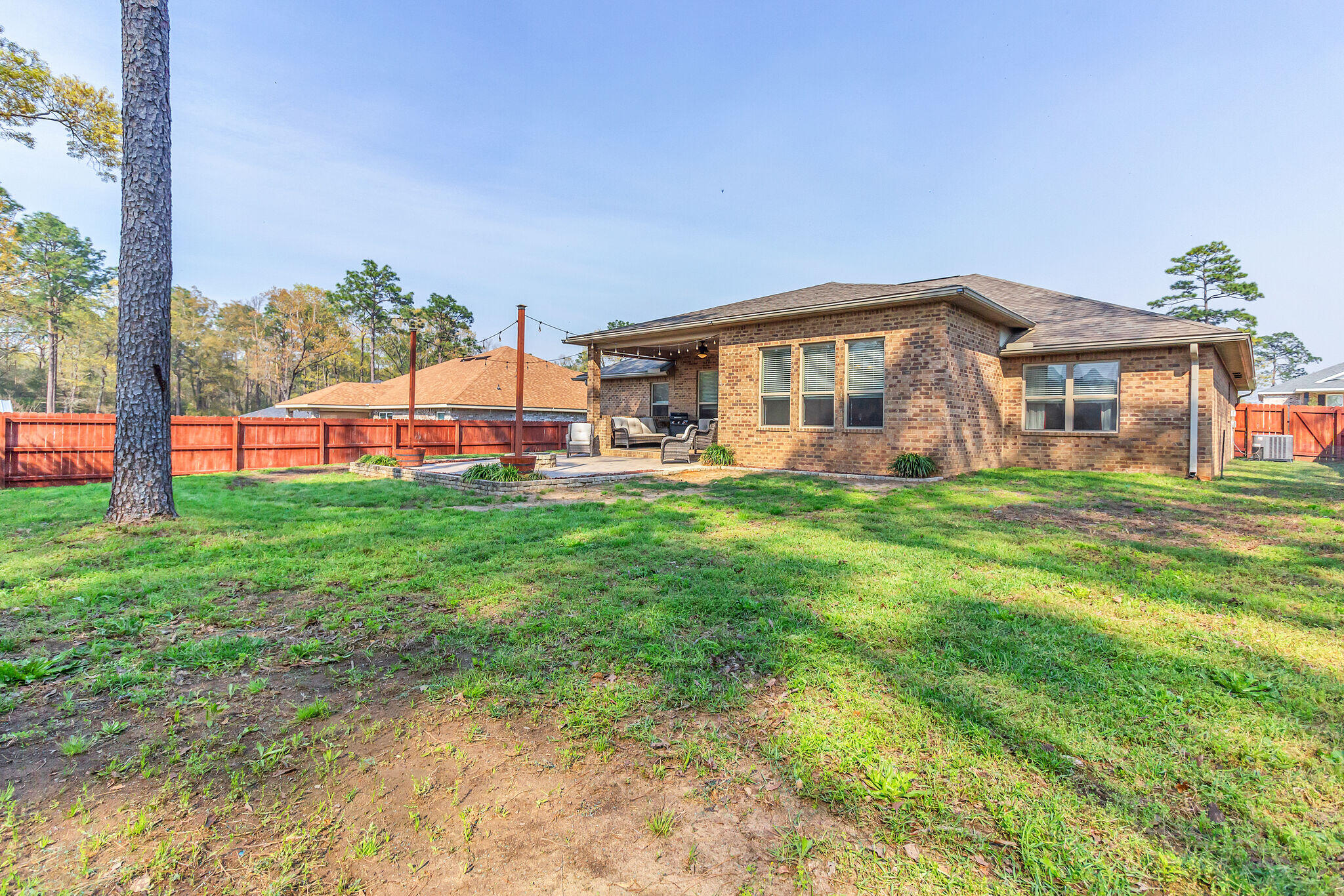 3044 Crown Creek Circle Crestview, FL 32539 - Photo 37 of 41 a front view of a house with a big yard and potted plants