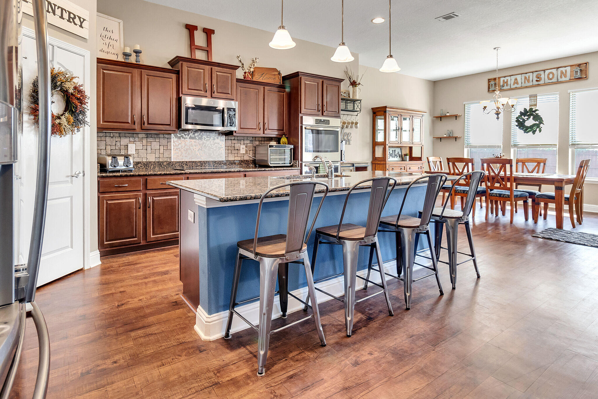 3044 Crown Creek Circle Crestview, FL 32539 - Photo 10 of 41 a kitchen with stainless steel appliances kitchen island granite countertop a table chairs sink and cabinets