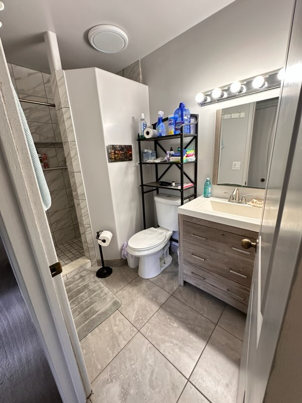 16-1562 Io Kea Rd Mountain View Mountain View, HI 96771 - Photo 13 of 30 a bathroom with a sink a toilet a mirror and shower