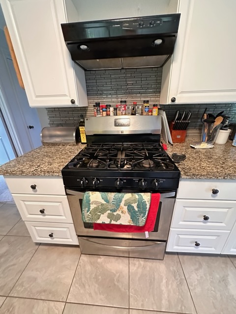 16-1562 Io Kea Rd Mountain View Mountain View, HI 96771 - Photo 26 of 30 a kitchen with stainless steel appliances granite countertop a stove and a microwave
