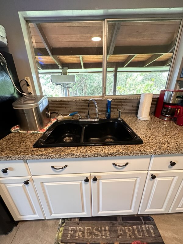 16-1562 Io Kea Rd Mountain View Mountain View, HI 96771 - Photo 27 of 30 a sink sitting next to a window